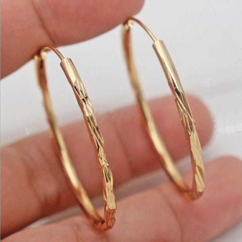 Gold hoop earrings on model
