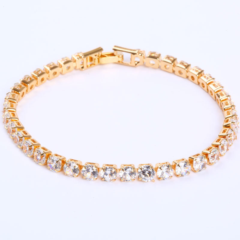 Gold cubic zirconia tennis bracelet on wrist